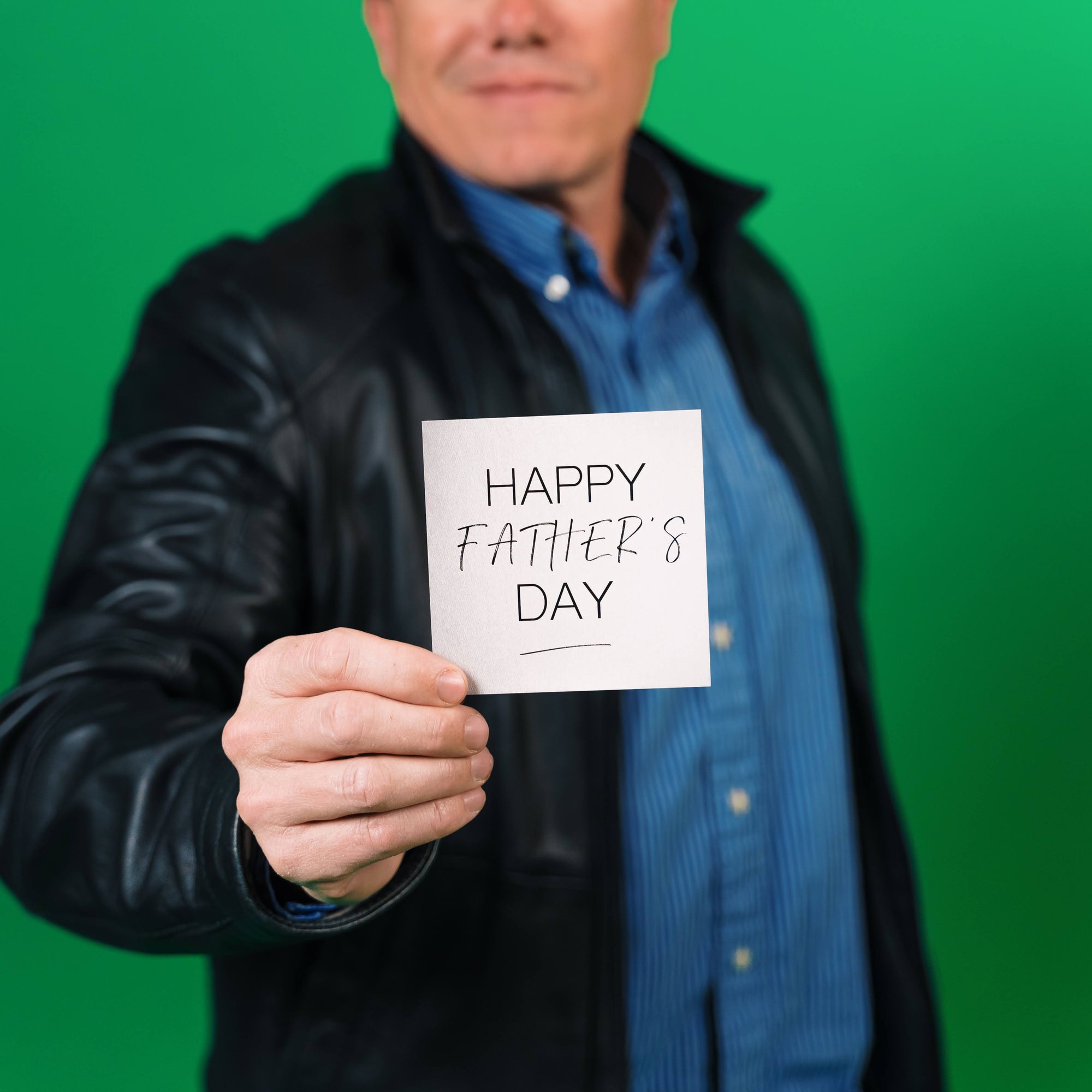 Dad holding note saying "Happy Father's Day" for Brightbox blog on Gifts for Him